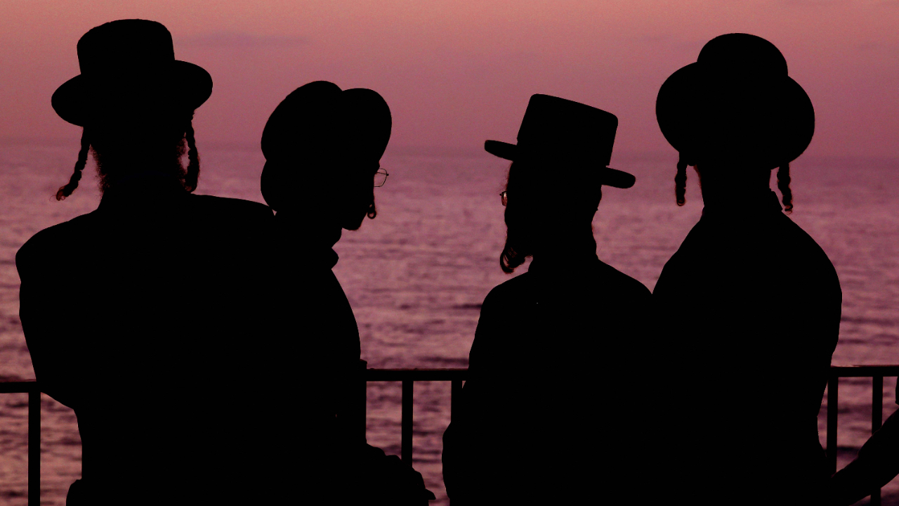 Ultra-Orthodox Jewish men and children perform the