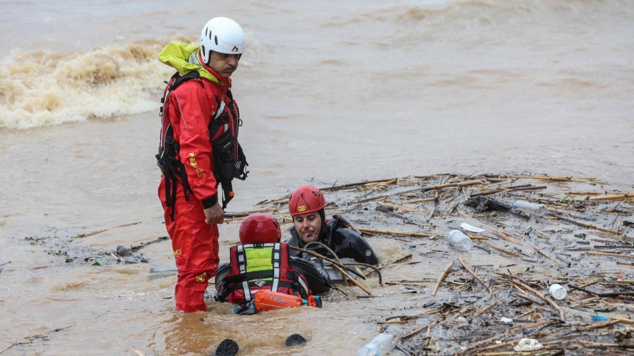 Rescuers search the waters along the beach of the popular resort of Agia Pelagia, on the southern Greek island of Crete, following flash floods on October 15, 2022. Credit: AFP Photo