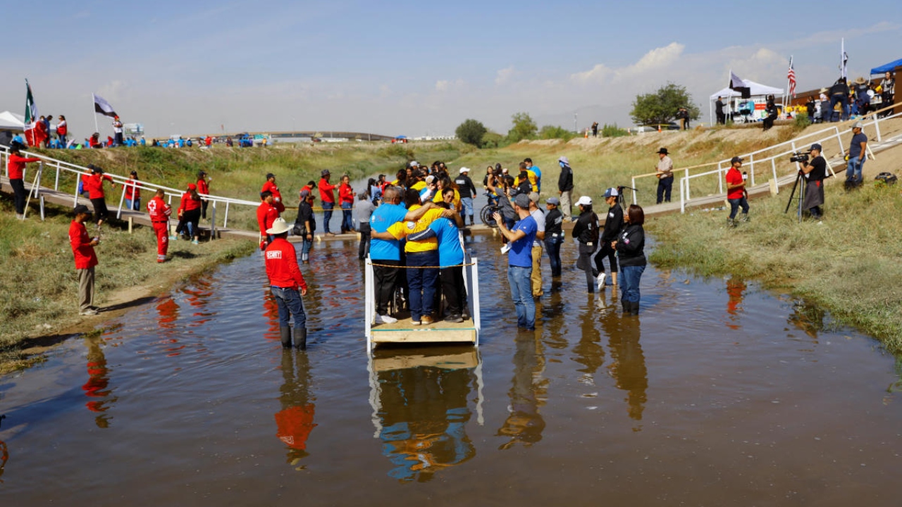 Families with mixed immigration status hug each other as they participate in a reunification meeting for relatives separated by deportation and immigration, called 'Hugs, Not Walls', in the Rio Bravo river borderline between Ciudad Juarez, Mexico and El Paso, US, in Ciudad Juarez, Mexico October 15, 2022. Credit: Reuters Photo