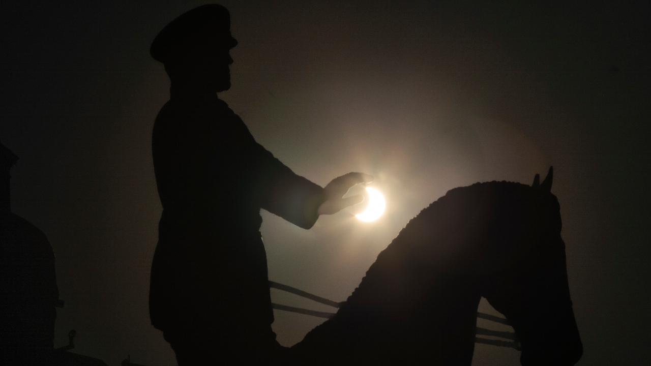 The moon covering a part of the sun during a partial solar eclipse at the monument of Soviet Marshal Georgy Zhukov in Moscow, Russia. Credit: AP Photo