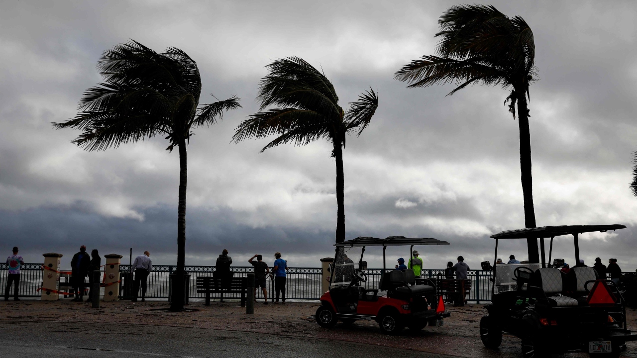 People look on from one of the access to the beach after Hurricane Nicole landfall at Vero Beach, Florida, on November 10, 2022. Credit: AFP Photo