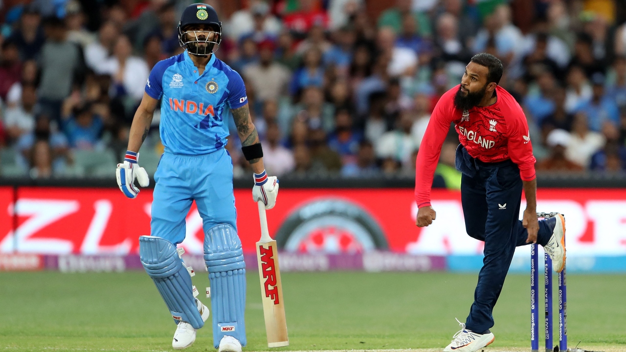 England's Adil Rashid bowls past India's Virat Kohli (L) during the ICC men's Twenty20 World Cup 2022 semi-final cricket match between England and India at The Adelaide Oval on November 10, 2022 in Adelaide. Credit: AFP Photo