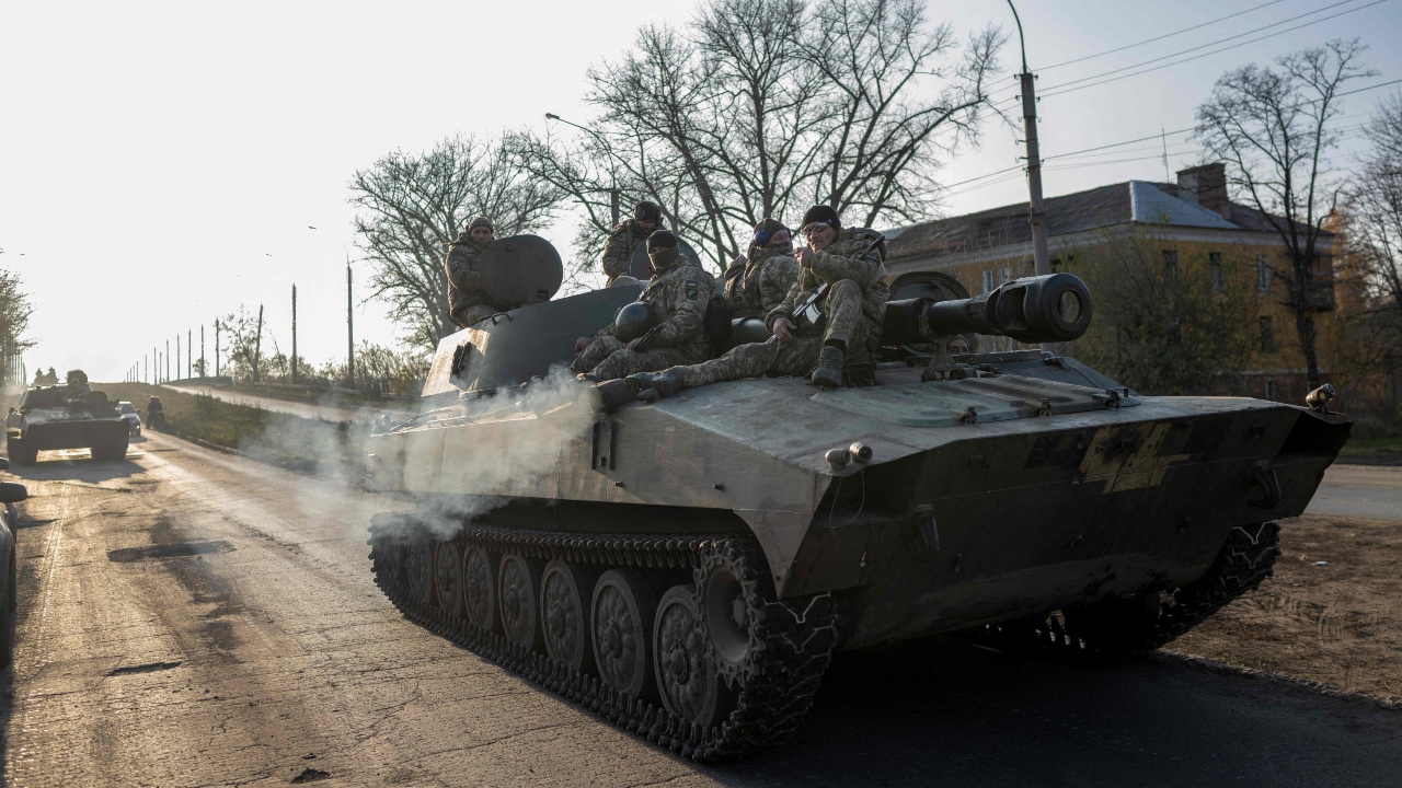 Ukrainian soldiers ride on a Self-propelled artillery 2S1 Gvozdika outside Bakhmut on November 9, 2022, amid the Russian invasion of Ukraine. Credit: AFP Photo