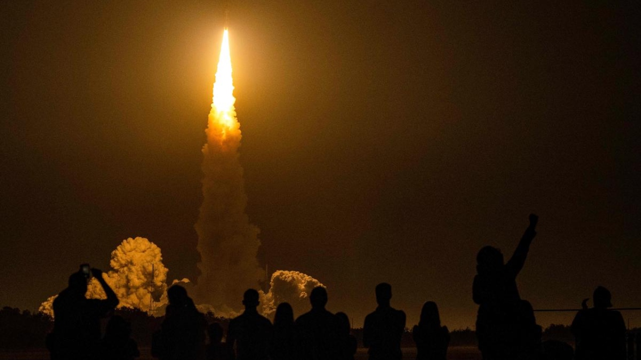 Spectators cheer as the Artemis I unmanned lunar rocket lifts off from launch pad 39B at NASA's Kennedy Space Center in Cape Canaveral, Florida, on November 16, 2022. Credit: AFP Photo