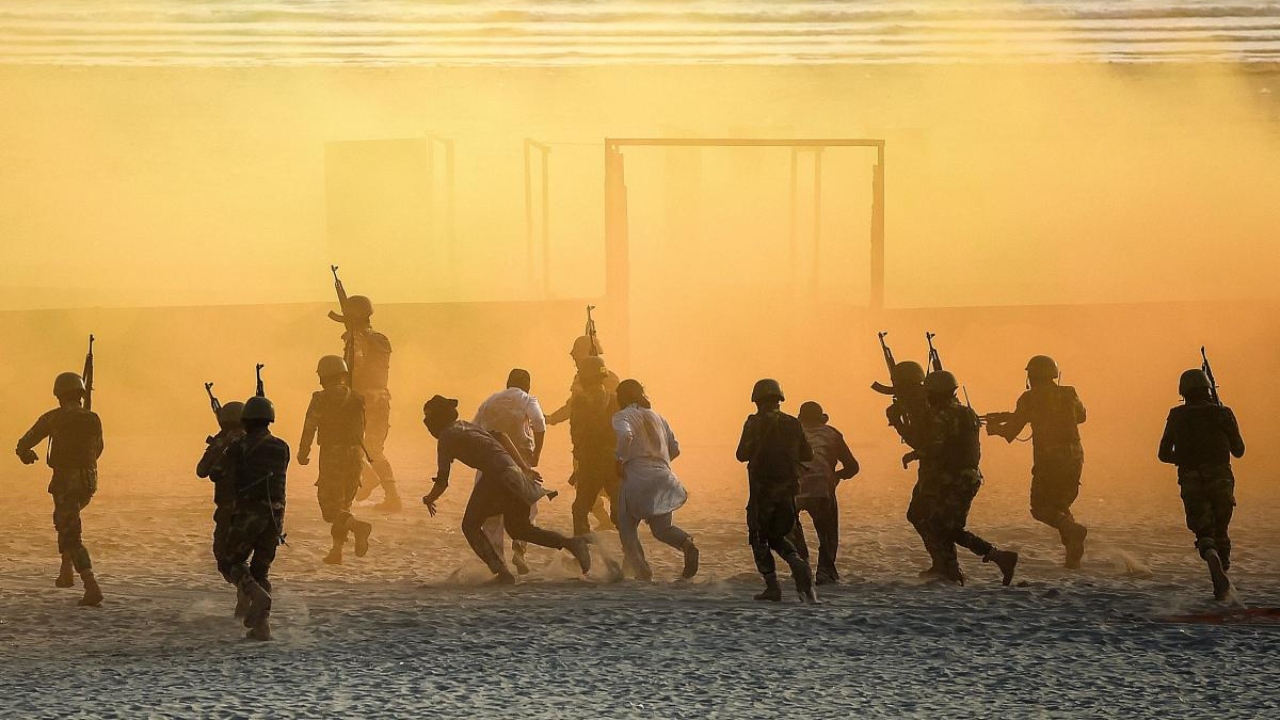Pakistani naval marine take part in a drill during the International Defence Exhibition and Seminar (IDEAS) 2022 at the beach in Karachi on November 17, 2022. Credit: AFP Photo