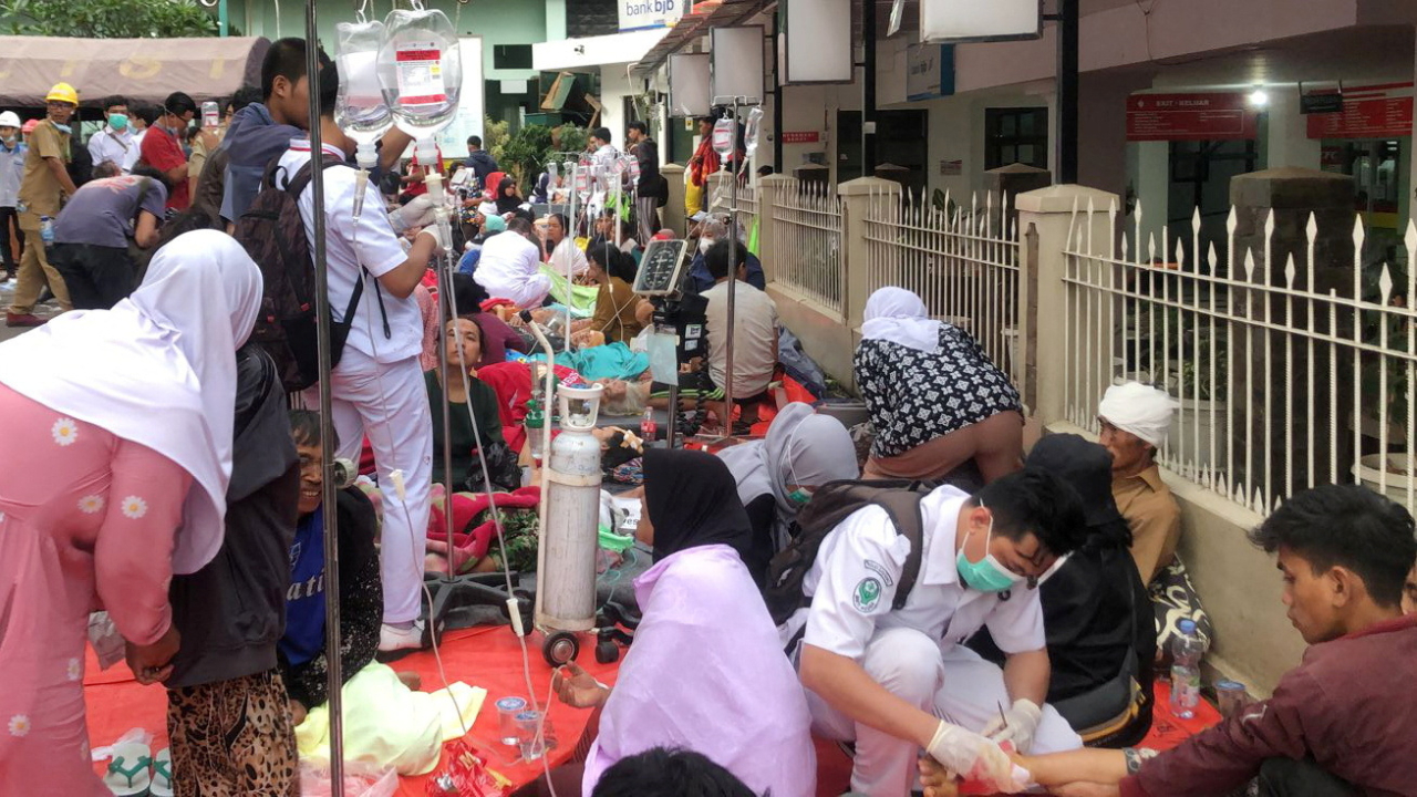 Medical workers treat the victims outside a hospital building after an earthquake hit Cianjur. Credit:Antara Foto/Raisan Al Farisi via Reuters