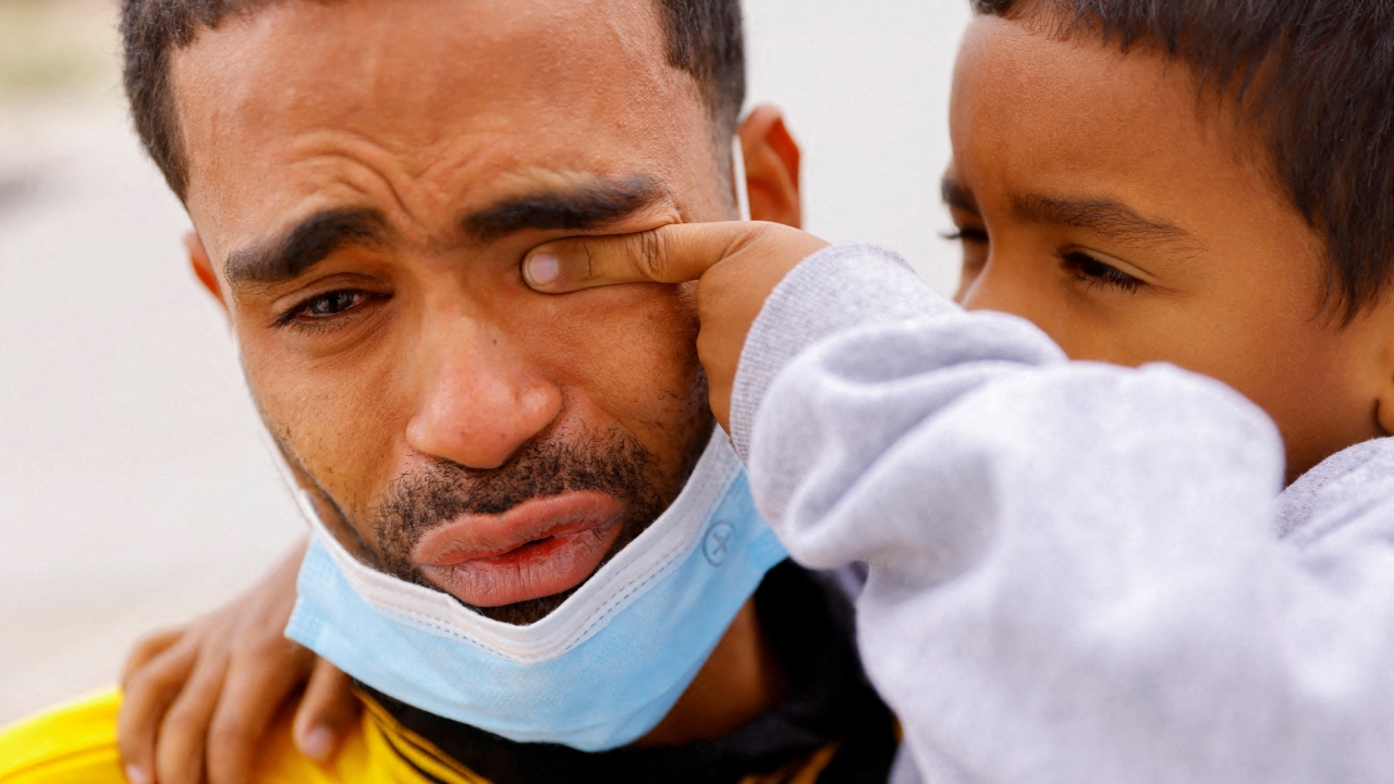A four-year-old child wipes the tears of his father after they were expelled from the US and sent back to Mexico under Title 42, near the Paso del Norte International border bridge, in Ciudad Juarez, Mexico. Credit: Reuters Photo
