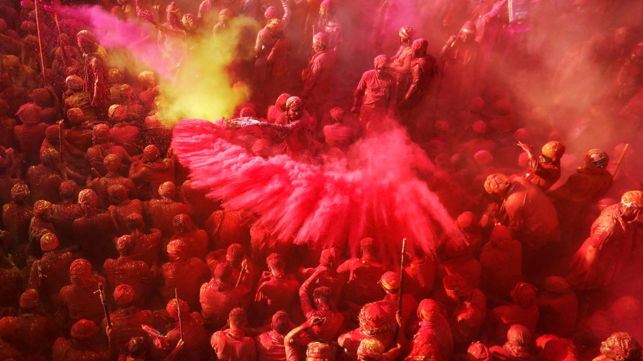Devotees play Holi inside a temple in Nandgaon village, in Uttar Pradesh. Credit: Reuters Photo