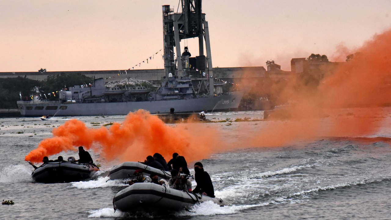 Navy personnel perform as part of the Navy Day celebrations in Kochi backwaters. Credit: PTI Photo