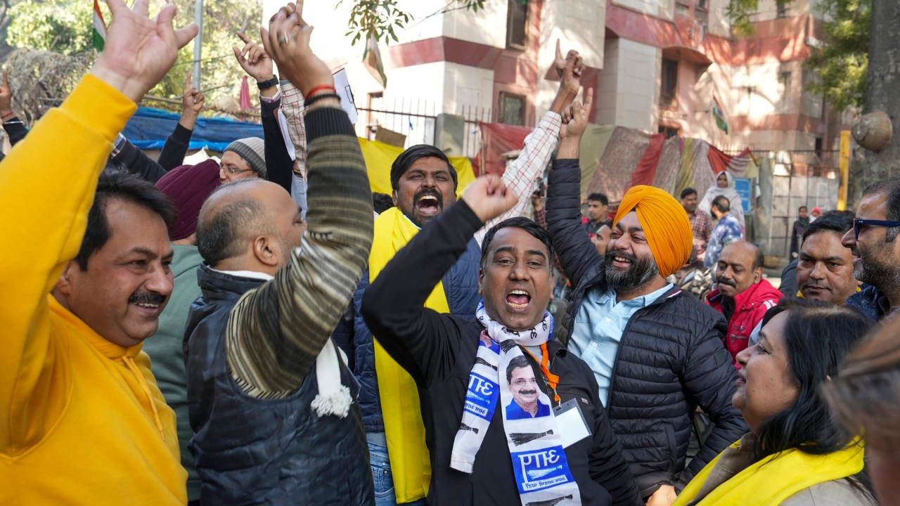 AAP supporters chant slogans as they celebrate their party's win at the MCD elections, in New Delhi. Credit: PTI Photo