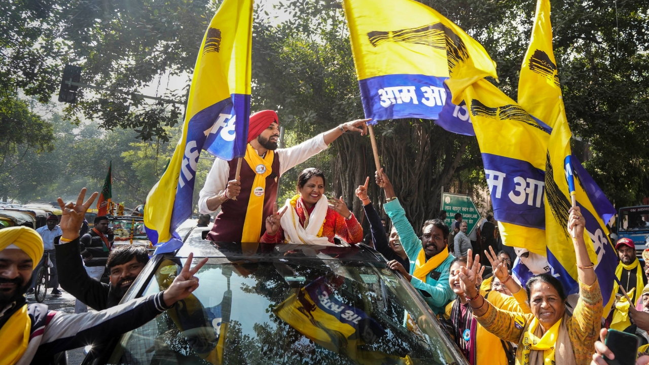AAP candidate from the Inder Puri ward Jyoti Gautam celebrates her win with supporters outside a counting centre for the MCD elections at Patel Nagar, in New Delhi. Credit: PTI Photo