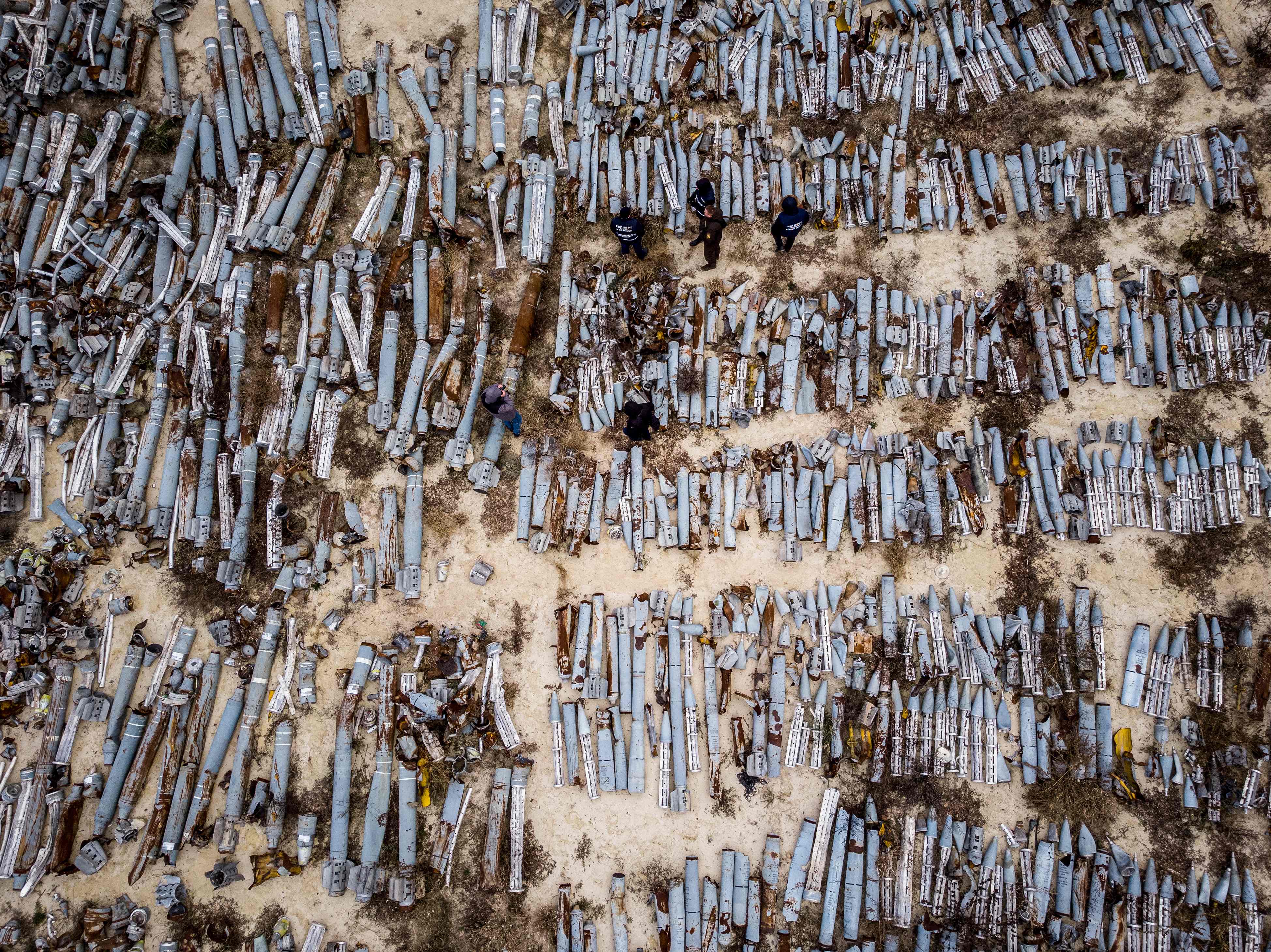 This aerial picture taken on December 7, 2022 shows experts and employees of the prosecutor's office examining collected remnants of shells and missiles used by the Russian army to attack the second largest Ukrainian city of Kharkiv. Credit: AFP Photo