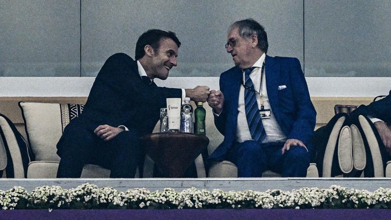 French President Emmanuel Macron (L) bumps fists with the president of the French Football Federation, Noël Le Graët, after France's forward #12 Randal Kolo Muani scored the team's second goal during the Qatar 2022 World Cup semi-final football match between France and Morocco at the Al-Bayt Stadium in Al Khor. Credit: AFP Photo