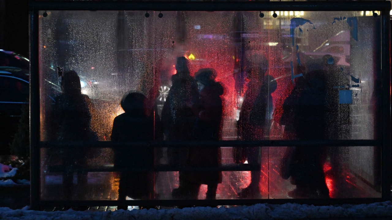 Local residents wait for a public bus as the Kyiv metro network remains out of service on December 16 2022, after Russian strikes targeted the power infrastructure. Credit: AFP Photo