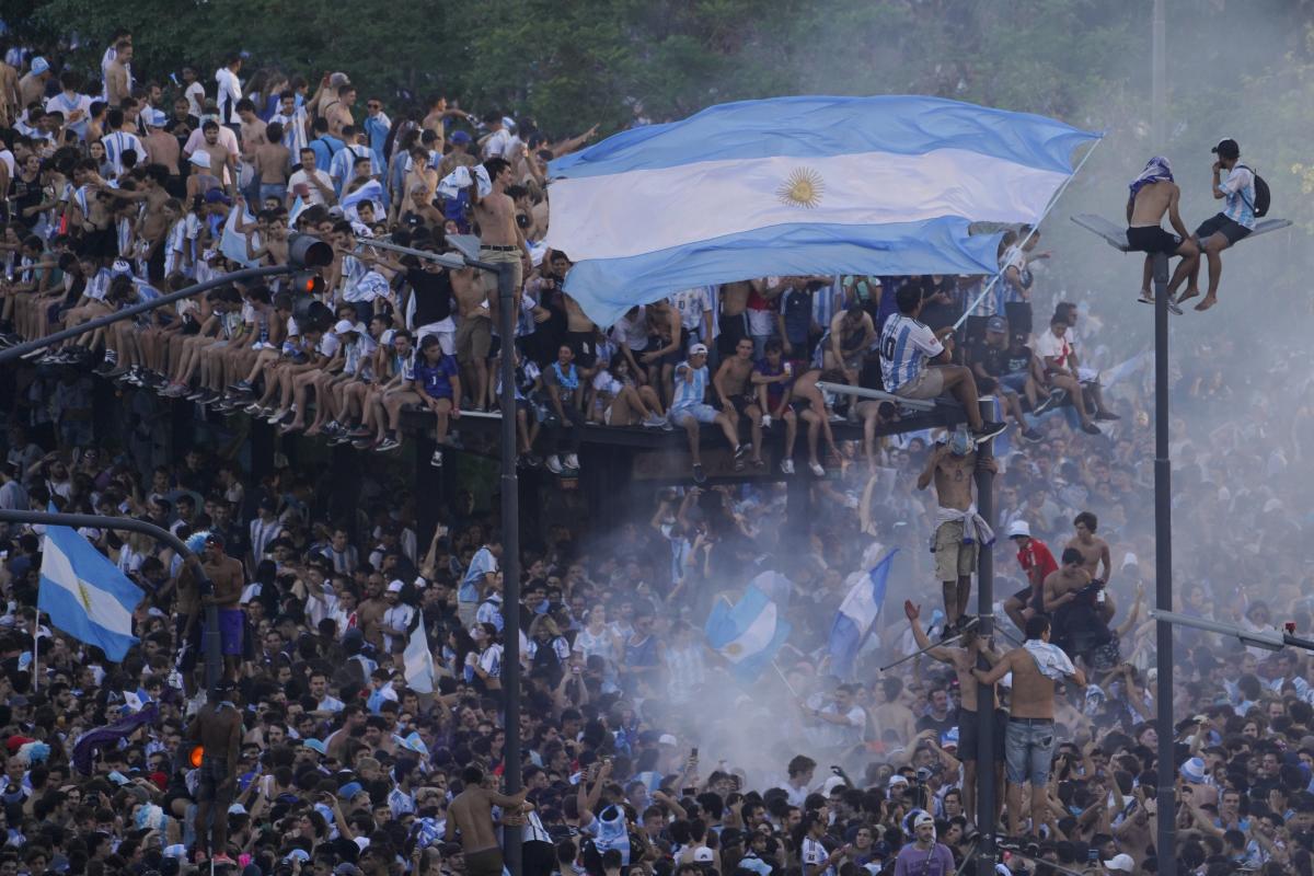 Fireworks cracked, car horns sounded and fans draped in the national blue and white colors sang, danced and waved flags. Credit: AP Photo