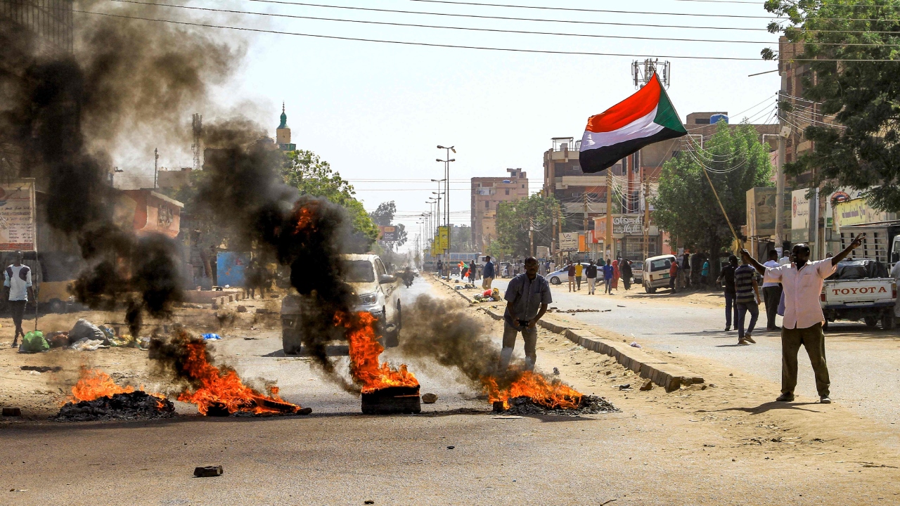 Tires are set aflame by Sudanese protesters during a demonstration against a tentative deal aimed at ending the crisis provoked by last year's military coup, in the Bashdar district in the south of Sudan's capital Khartoum on December 19, 2022. Credit: AFP Photo