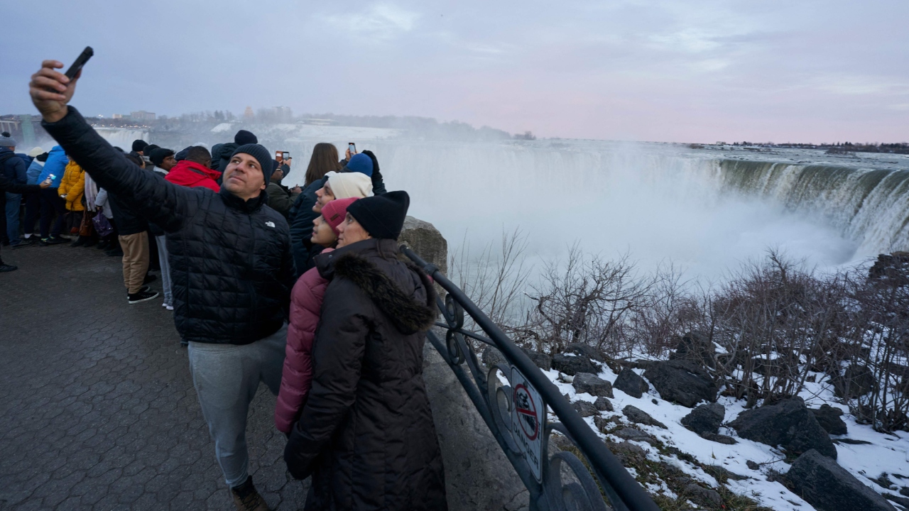 Tourists take photographs at the Horseshoe Falls in Niagara Falls, Ontario. Credit: AFP Photo