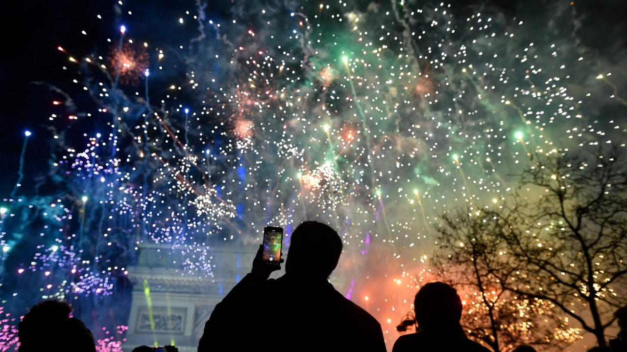 Fireworks explode next to the Arc de Triomphe, at the Avenue des Champs-Elysees during New Year celebrations in Paris. Credit: AFP Photo