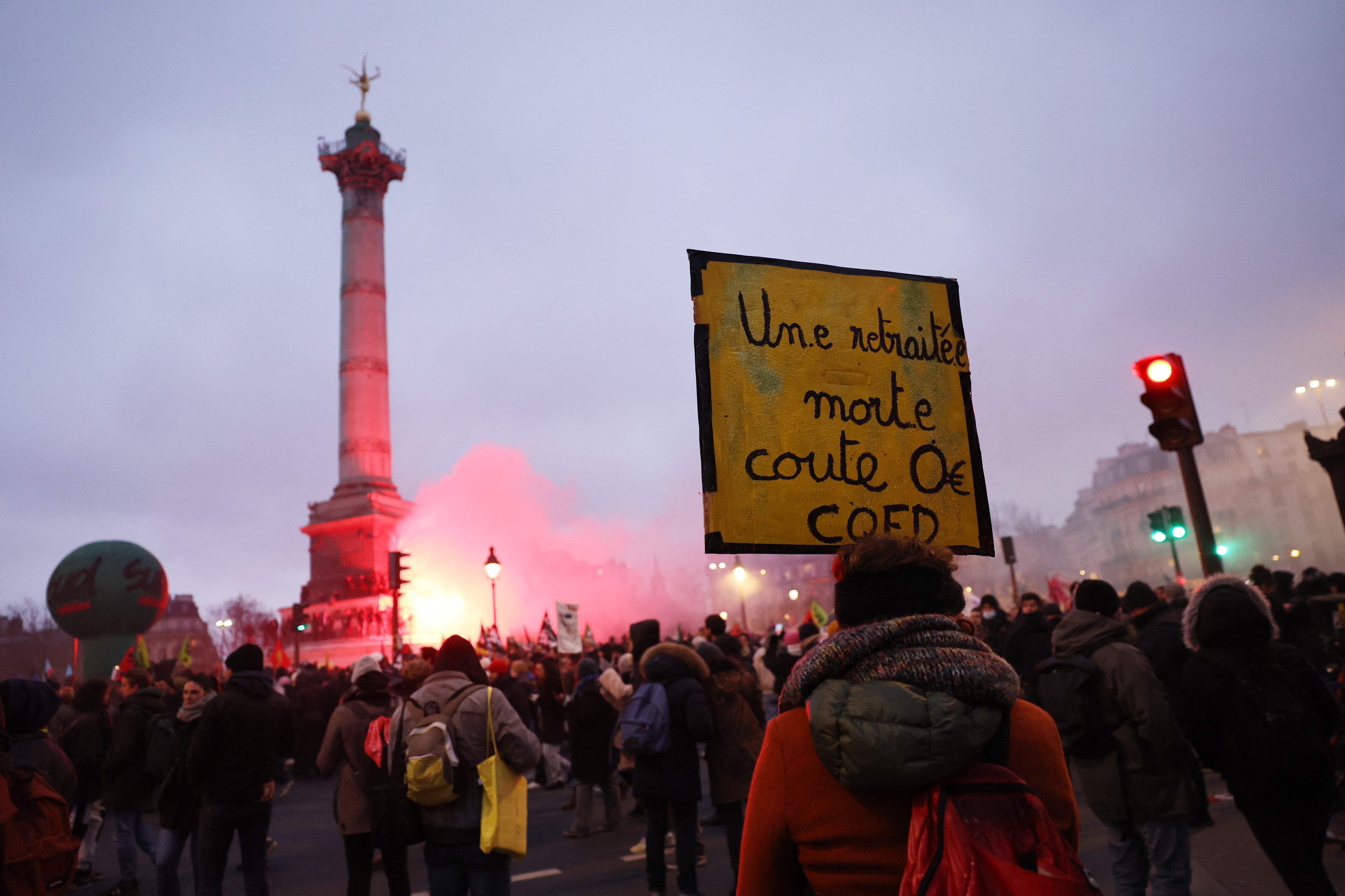 A protester holds a placard reading