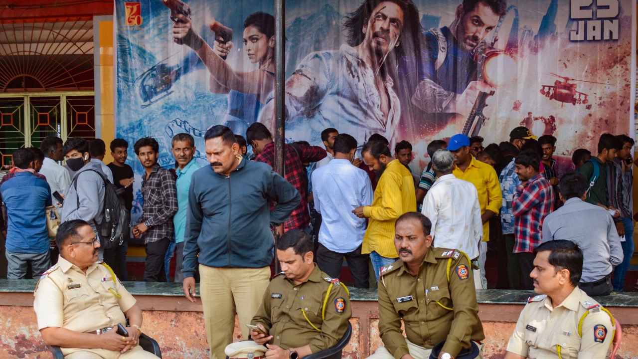 Police keep a strict vigil outside a theatre on the first day show of the Bollywood movie 'Pathaan', in Karad. Credit: PTI Photo