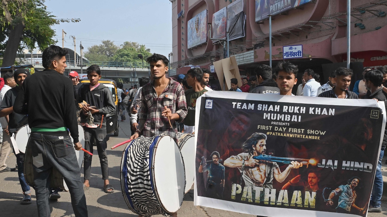 Fans of Shah Rukh Khan play dhols as they celerbate the release of his movie 'Pathaan' in Mumbai. Credit: AFP Photo