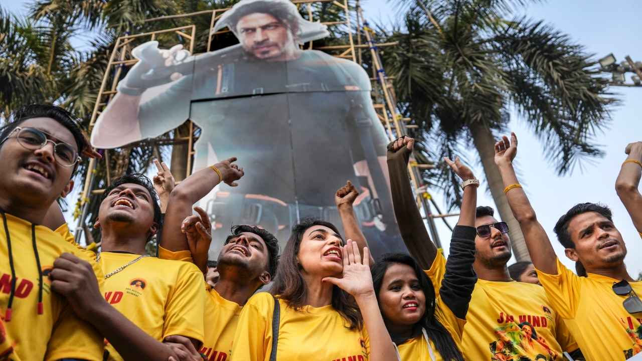 Shah Rukh Khan Fans Club members shout slogans outside a theatre during the first day first show of Bollywood movie Pathaan, in Mumbai. Credit: PTI Photo