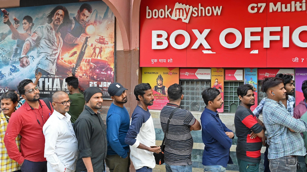 SRK fans stand in a queue as they wait to watch the Bollywood movie 'Pathaan' at a cinema hall in Mumbai. Credit: AFP Photo
