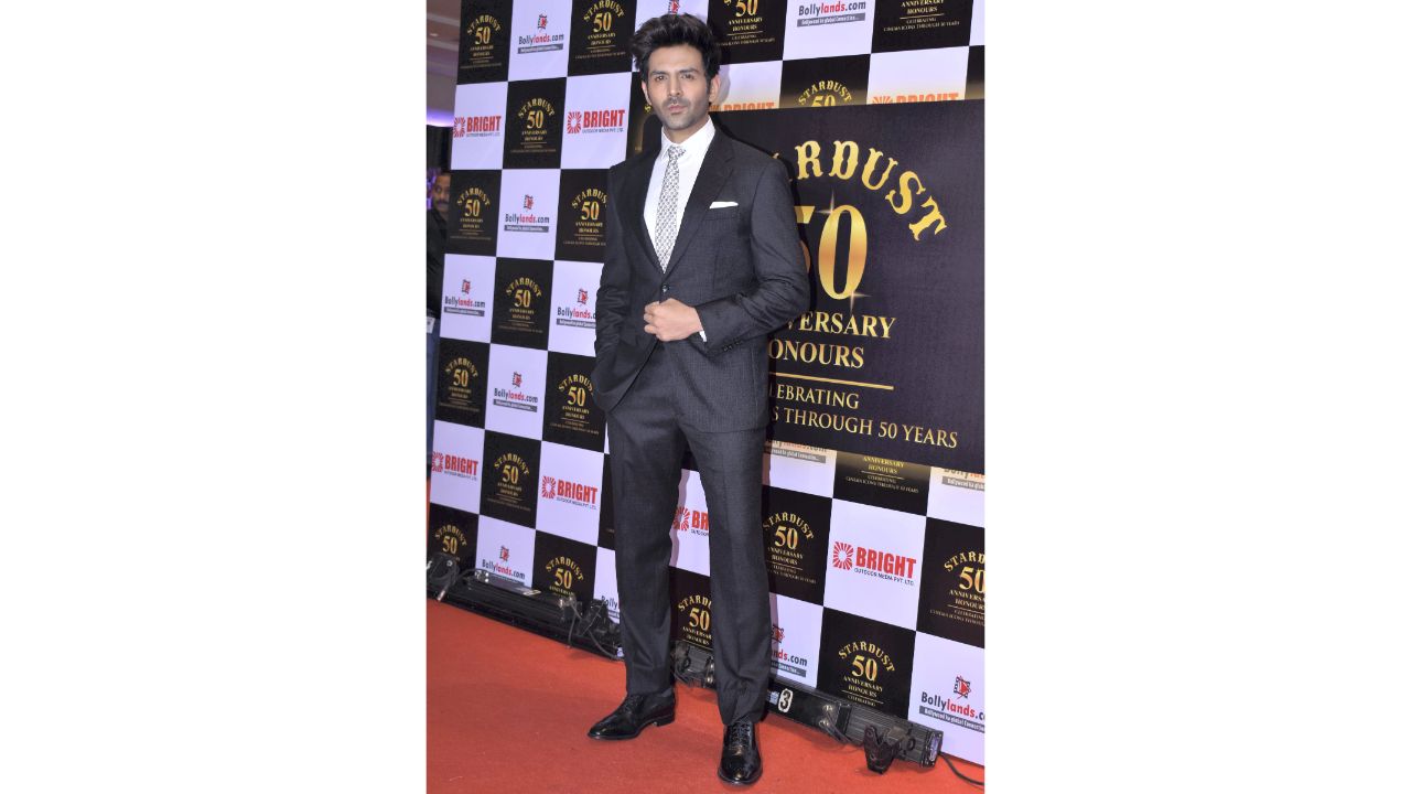 'Shehzada' Kartik Aaryan looked dapper in a suit at the 50th anniversary party of Stardust Magazine in Mumbai. Credit: PTI Photo