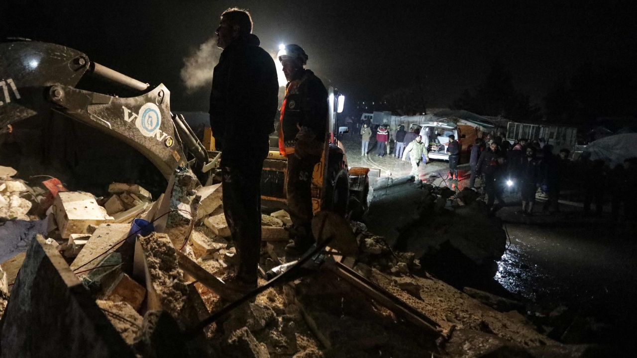 Television images showed shocked people in Turkey standing in the snow in their pyjamas watching rescuers dig through the debris of damaged homes. Credit: AFP Photo