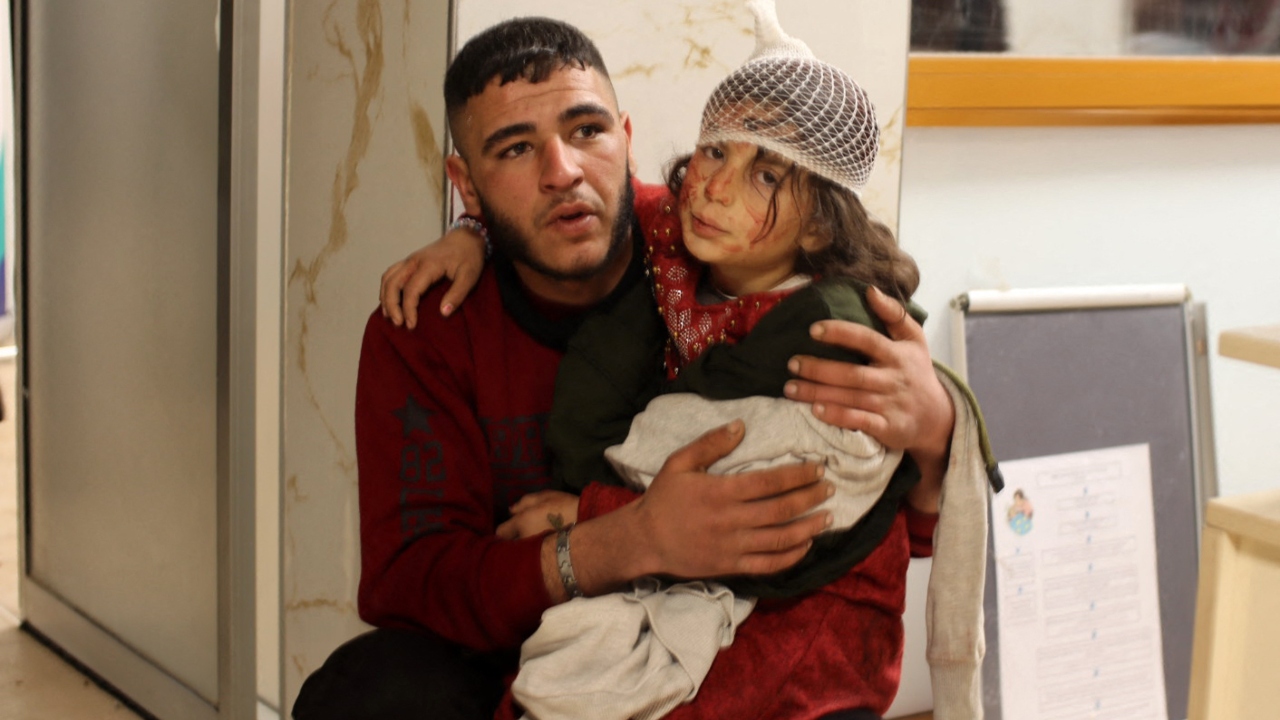 A young injured girl awaits treatment at a hospital, following the earthquake, in the border town of Azaz in the rebel-held north of the Aleppo province. Credit: AFP Photo