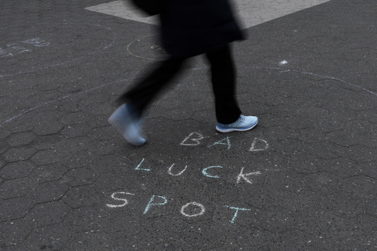 A woman walks by a chalk statement on cement in the Union Square area of New York City. Credit: Reuters Photo