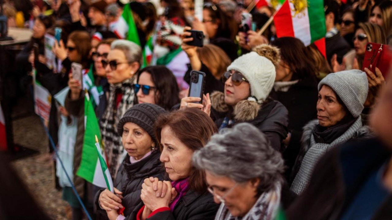 People listen to a speaker during a demonstration to denounce the Iranian government and express support with anti-government protesters in Iran, in Washington, DC, on February 11, 2023. Credit: AFP Photo