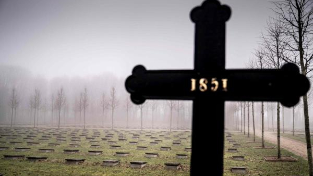 Headstones of graves are pictured near a cross at Gudsageren (God's Field) cemetery in Christiansfeld, Denmark. Credit: AFP Photo