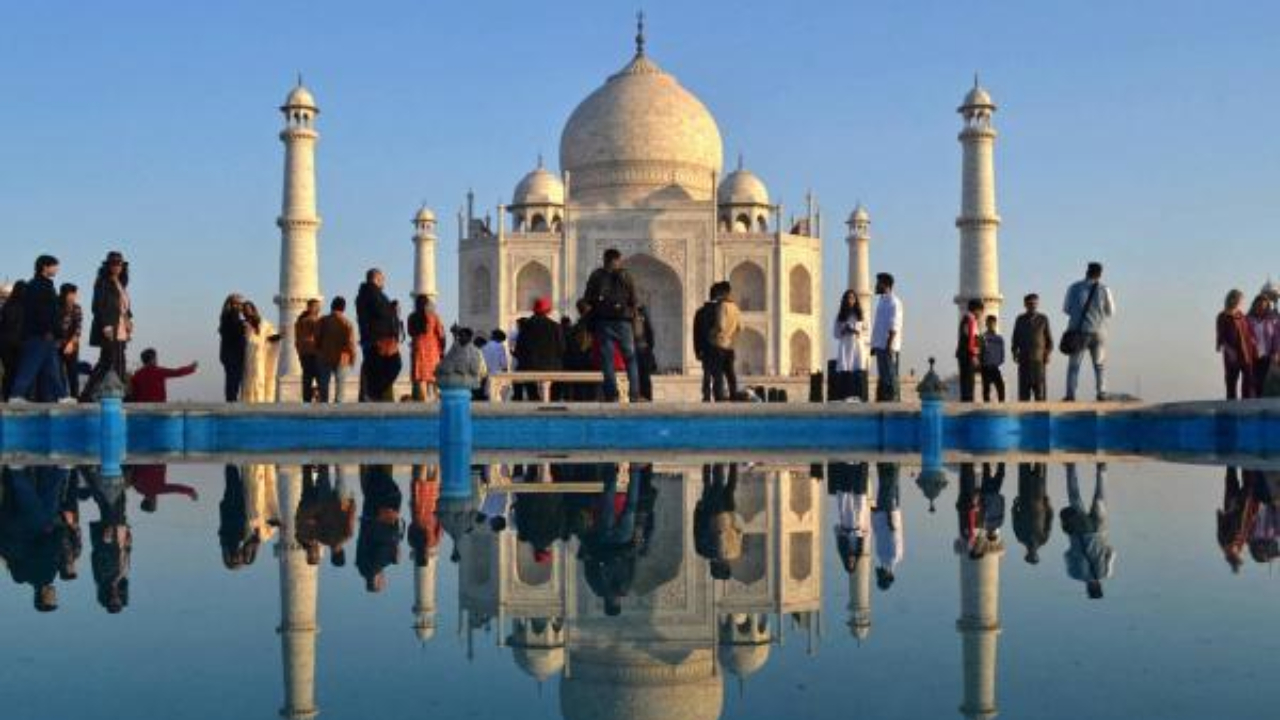 Tourists visit the Taj Mahal during early morning in Agra. Credit: AFP Photo