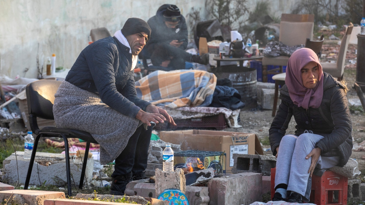 People wait as they see rescuers search for their missing relatives under the debris of a building in the aftermath of the deadly earthquake in Hatay province, Turkey. Credit: Reuters Photo