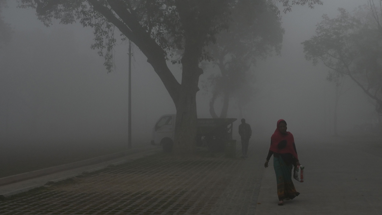 People walk along a road near India Gate amid heavy smog in New Delhi on February 22, 2023. Credit: AFP Photo