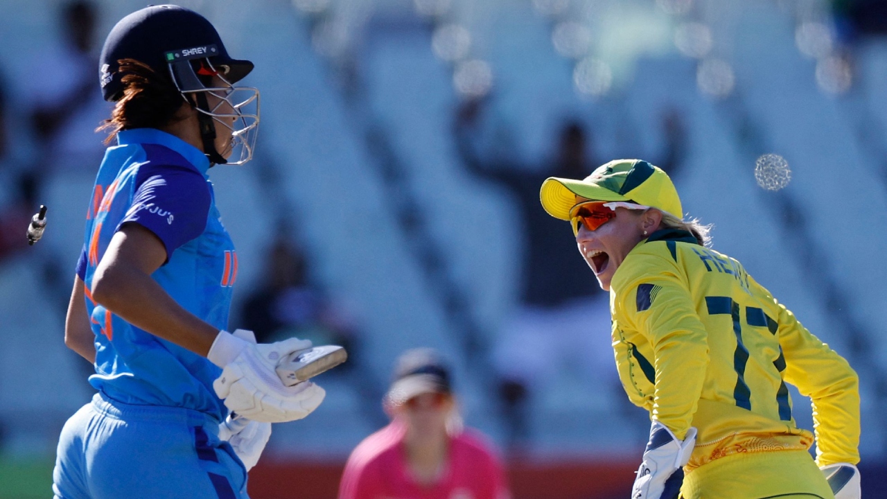 Australia's wicketkeeper Alyssa Healy (R) celebrates after runnning out India's Yastika Bhatia (L) during the semi-final T20 women's World Cup cricket match between Australia and India at Newlands Stadium in Cape Town on February 23, 2023. Credit: AFP Photo