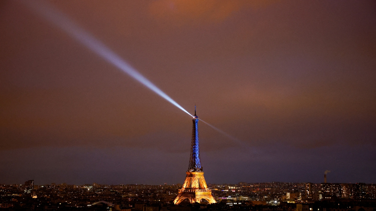 The Eiffel Tower is lit up in the national blue-and-yellow colours of Ukraine, to mark the first anniversary of Russia's invasion of Ukraine, in Paris, France, February 23, 2023. Credit: Reuters Photo