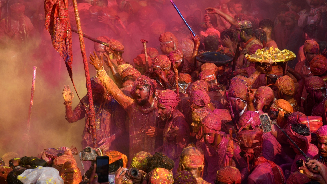 Daubed in colours, people sing songs as they play Holi in Nandgaon, Uttar Pradesh. Credit: PTI Photo