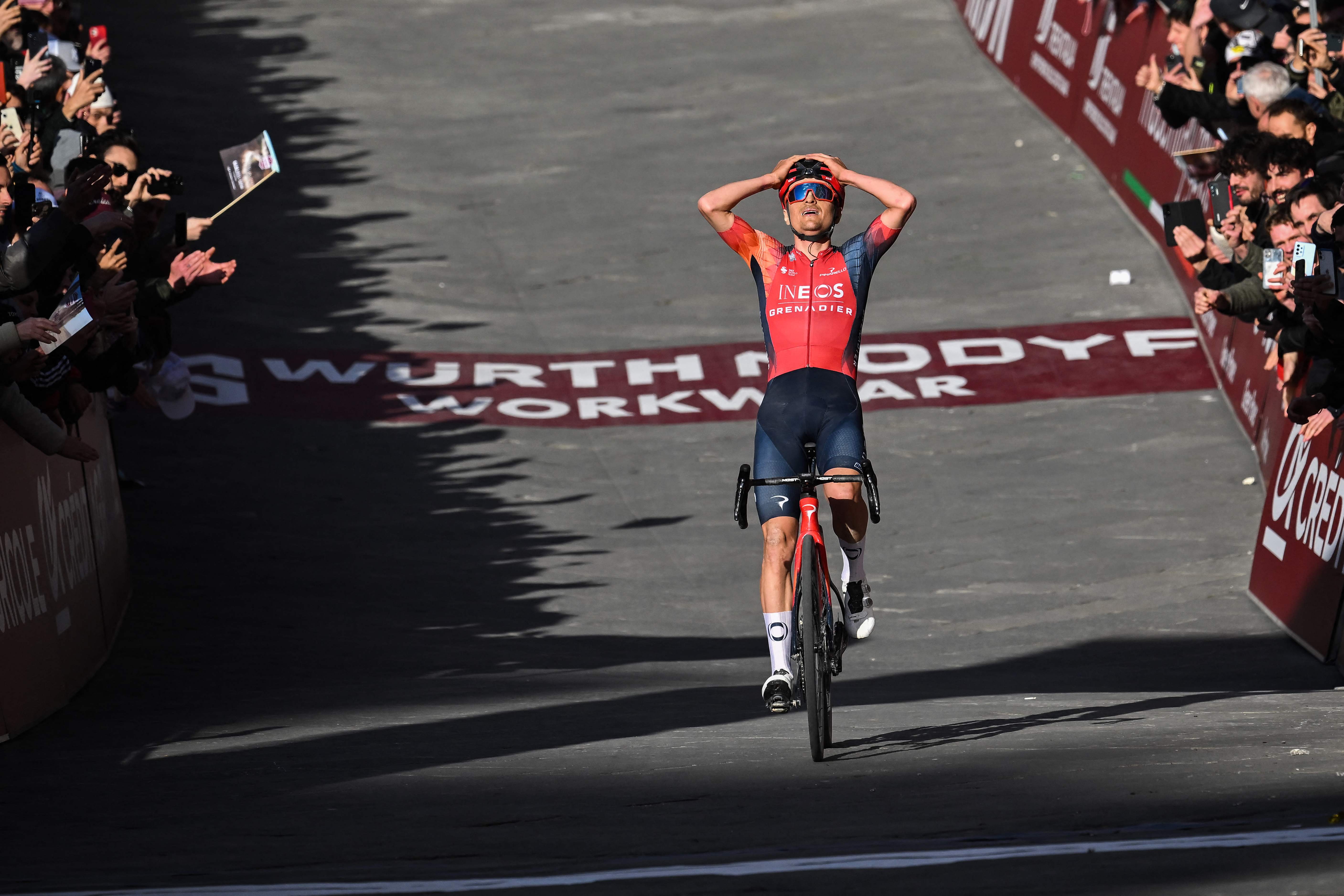 Team Ineos' Thomas Pidcock celebrates as he crosses the finish line to win the 17th one-day classic 'Strade Bianche' (White Roads) cycling race. Credit: AFP Photo