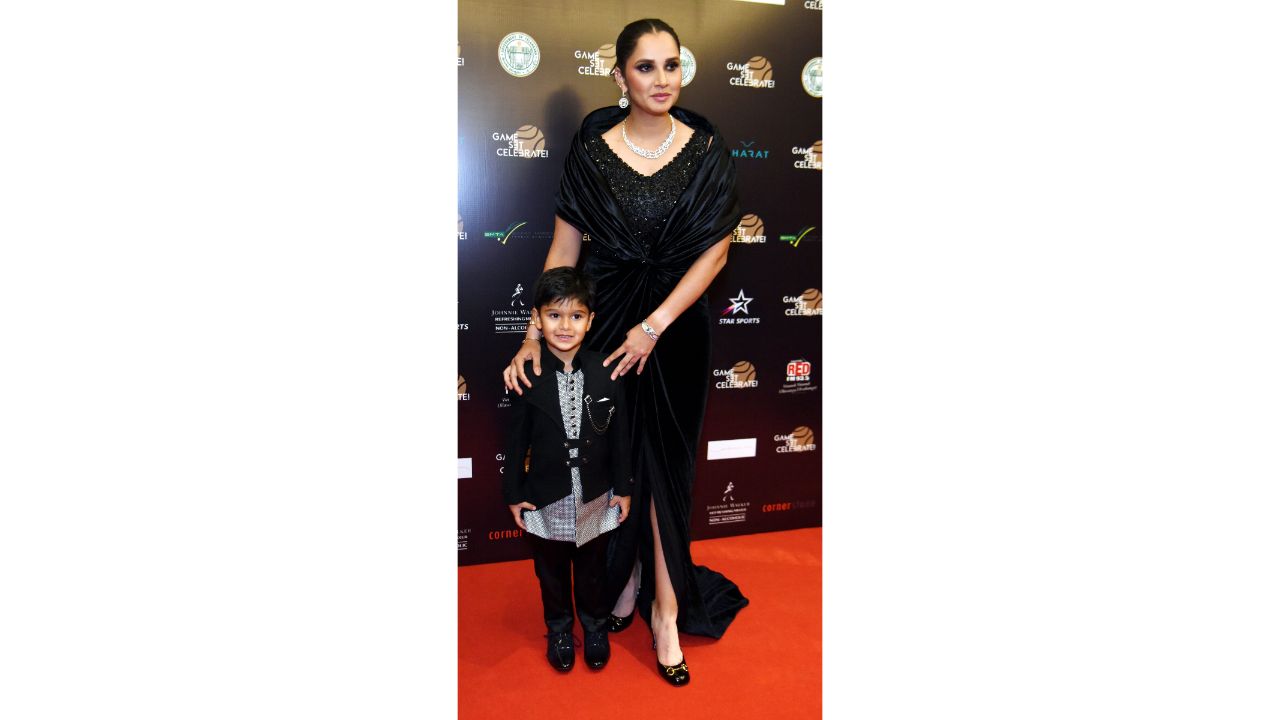 Sania Mirza looked gorgeous in black designer ensemble. In this photo, she is seen posing with her son Izhaan Mirza Malik. Credit: PTI Photo