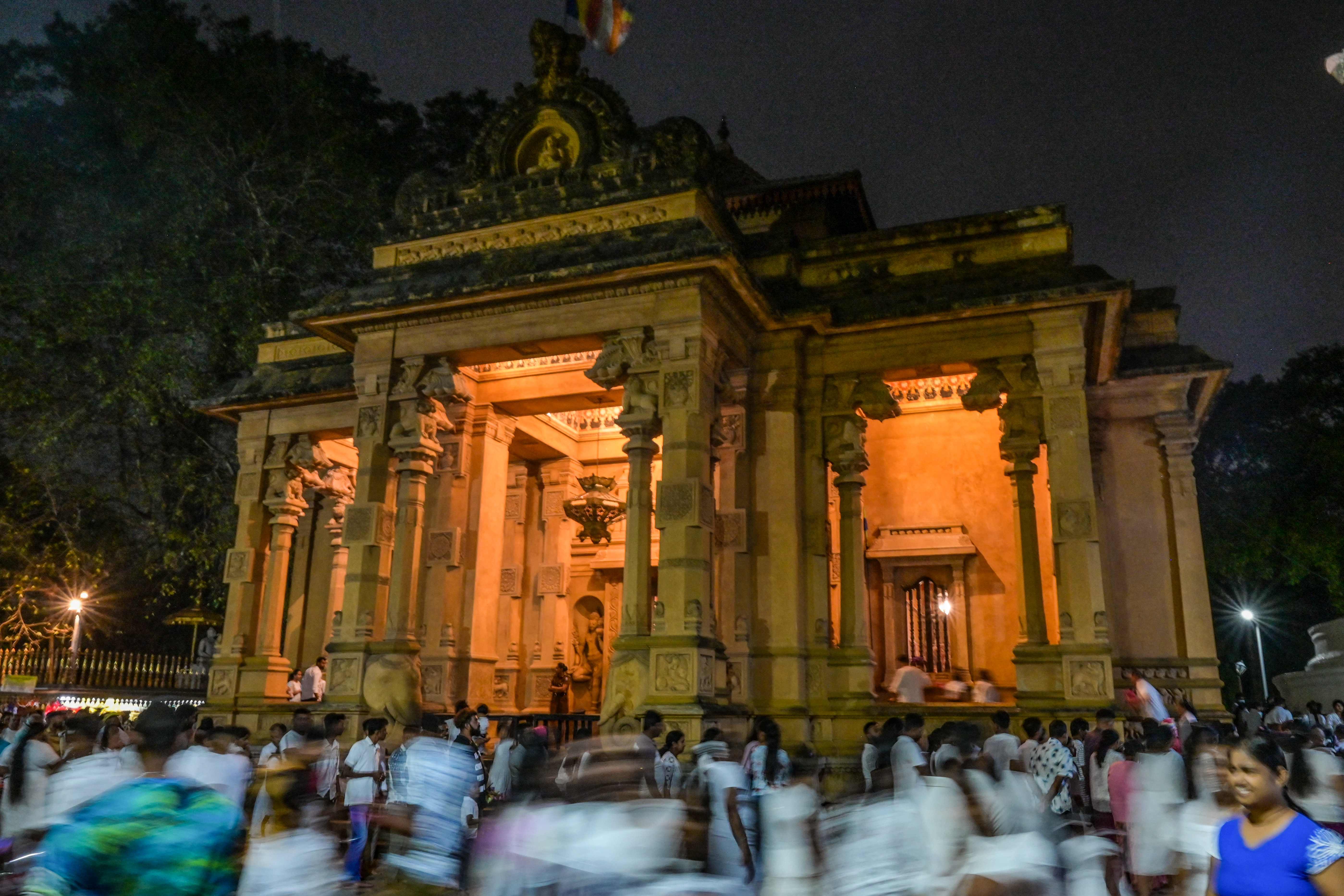 Buddhist devotees gather to offer prayers during Poya a religious festival to mark the full moon, at the Kelaniya Buddhist temple in Kelaniya. Credit: AFP Photo
