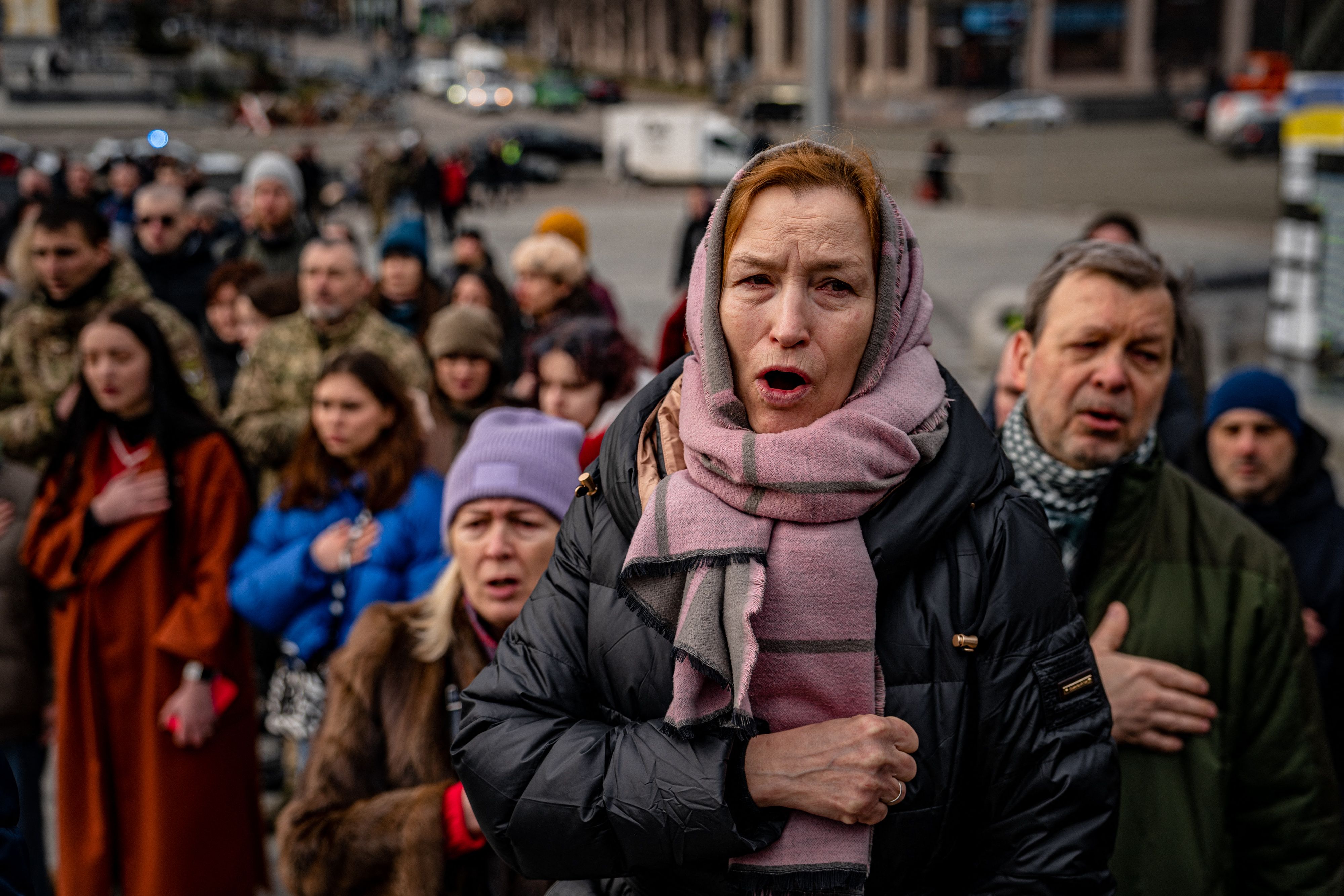 People sing the Ukrainian national anthem during a ceremony for slain Ukrainian volunteers Yuriy Horovets, Maksym Mykhaylov, Taras Karpyuk, and Bohdan Lyagov in the Independence Square in Kyiv. Credit: AFP Photo
