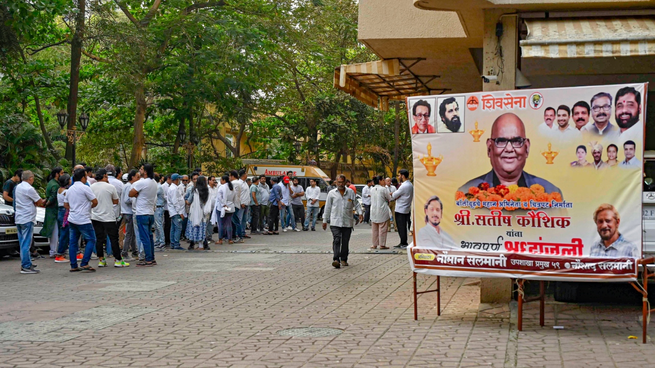 People wait to pay their last tributes to Satish Kaushik during his funeral in Mumbai. Credit: PTI Photo