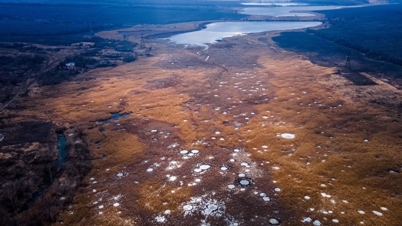 Crater holes in the fields following strikes during the fighting in summer 2022, in the village of Dolyna, Donetsk region, amid the Russian invasion of Ukraine. Credit: AFP Photo
