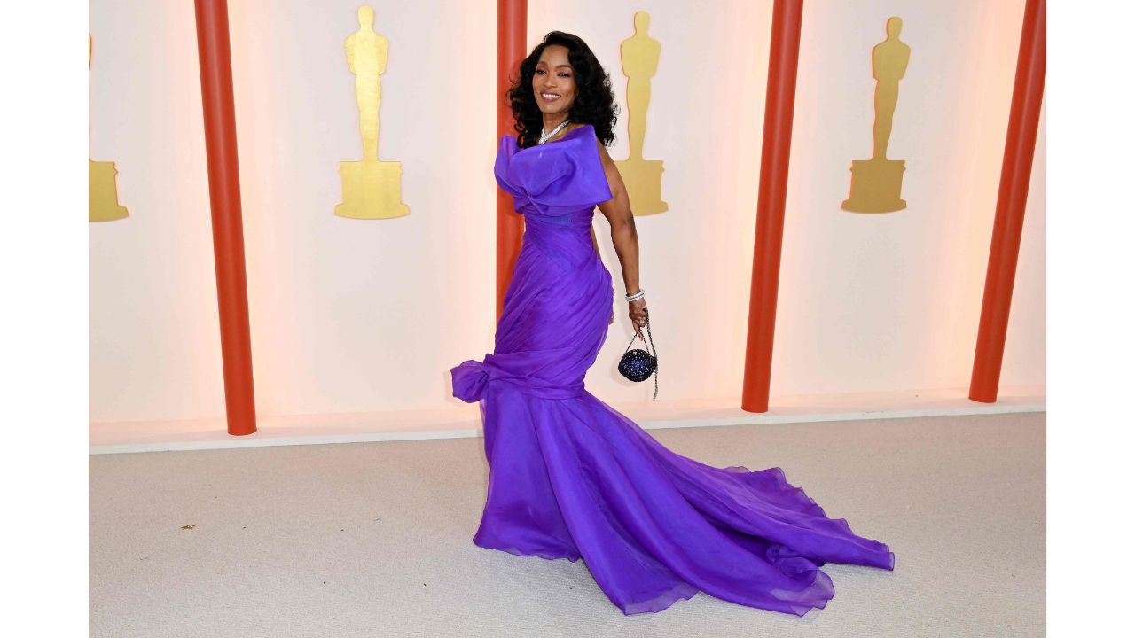 Angela Bassett wore a flowing Moschino purple gown that she described as “the color of royalty”. Credit: AFP Photo