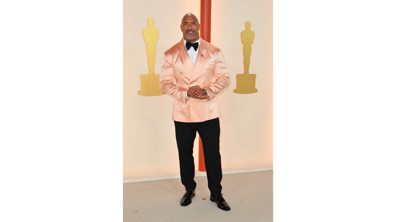 Dwayne Johnson arrived in a Dolce & Gabbana pink tuxedo jacket, paired with black trouser and white shirt. Credit: AFP Photo