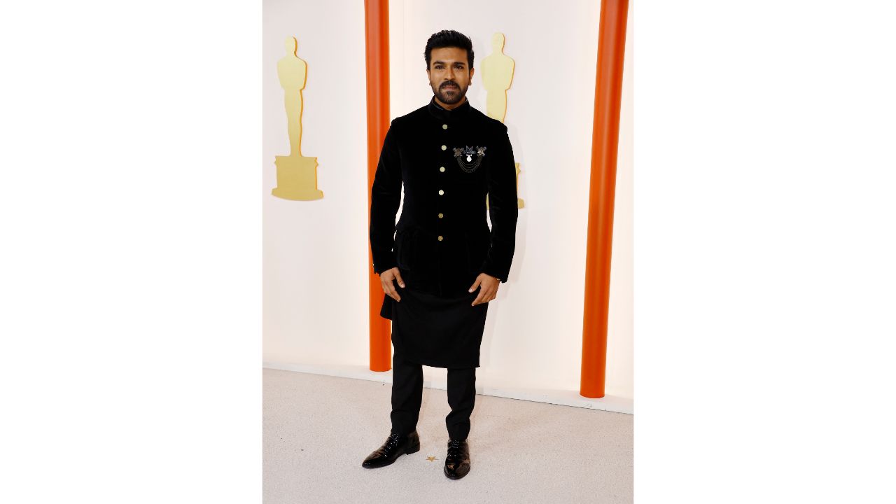 Ram Charan opted for a three-piece ensemble that featured a 'bandhgala' jacket, an asymmetrical kurta, and straight-fitted pants. The outfit was custom-made by Shantanu & Nikhil and styled by Nikita Jaisinghani. Credit: Reuters Photo