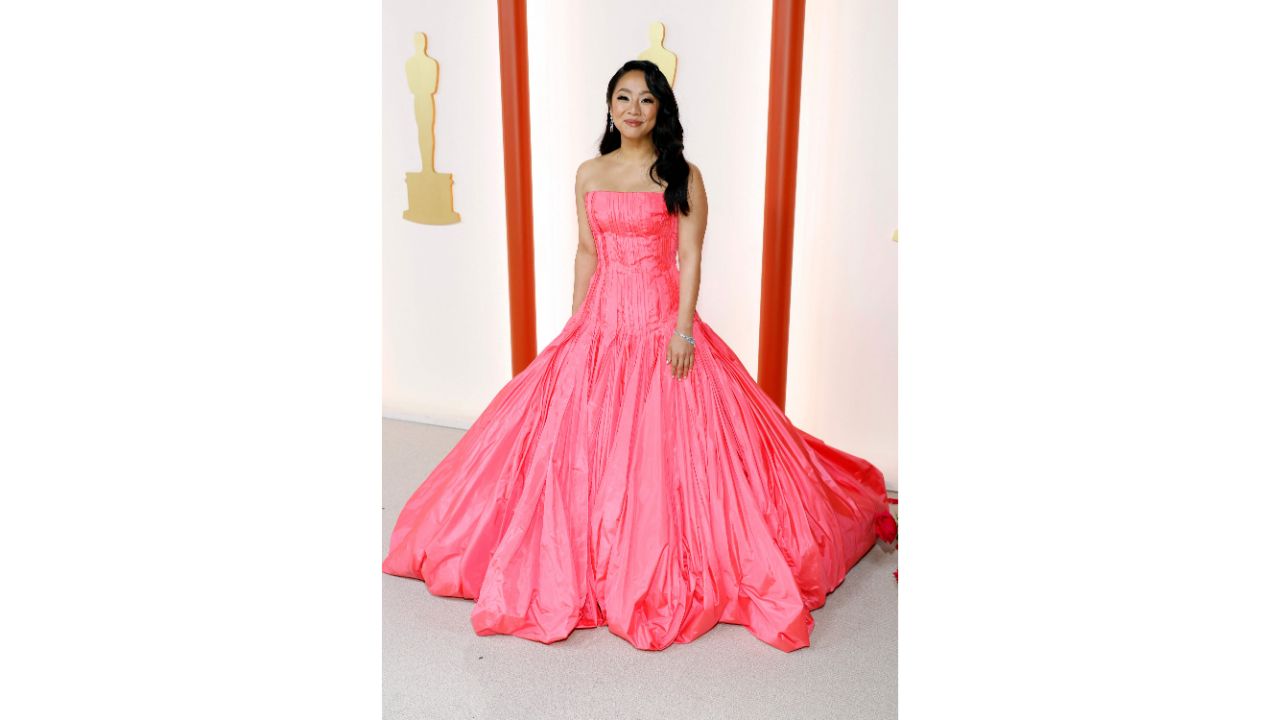 Stephanie Hsu attended the Oscars in a strapless ballgown, which she paired with simple — if not sparkly — jewelry and side-swept hair in loose waves. Credit: AFP Photo
