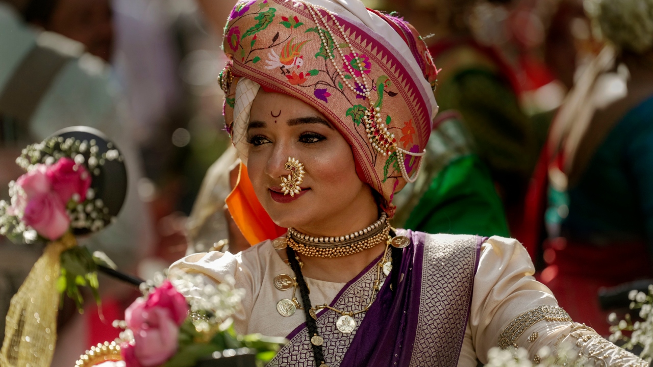 A woman dressed in traditional attire rides a motorcycle during a procession to mark 'Gudi Padwa' or the Marathi New Year, in Mumbai. Credit: AFP Photo